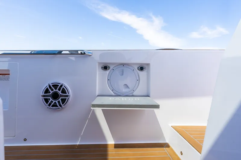 Slide: The Image of Pardo Yachts P43R 2027 deck detail with speaker and foldable table against blue sky. - 58