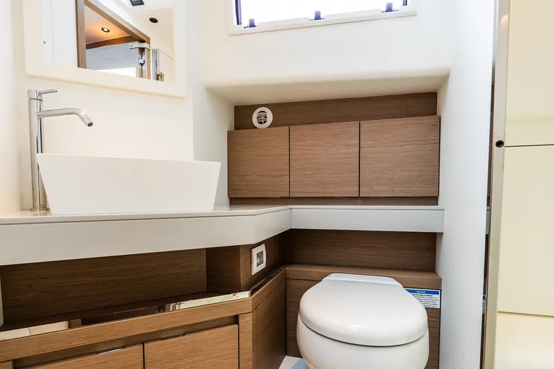 Slide: The Image of Modern bathroom interior on 2027 Pardo Yachts P43R, featuring sleek sink and wooden cabinetry. - 27