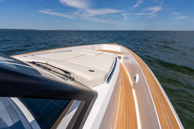 Slide: The Image of 2027 Pardo Yachts P43R cruising on open water under a clear blue sky. - 41