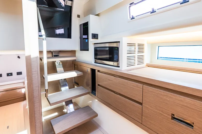 Slide: The Image of Modern interior of 2027 Pardo Yachts P43R with sleek kitchen and wooden stairs. - 25