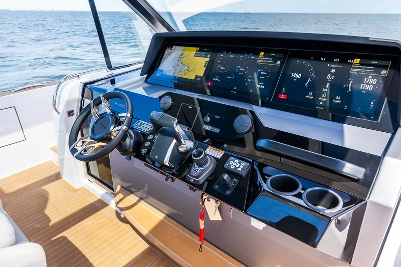 Slide: The Image of Helm of 2027 Pardo Yachts P43R with advanced navigation displays and controls. - 55