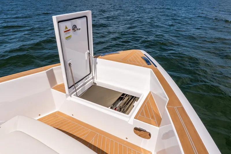 Slide: The Image of 2027 Pardo Yachts P43R with open hatch on teak deck, ocean backdrop. - 45