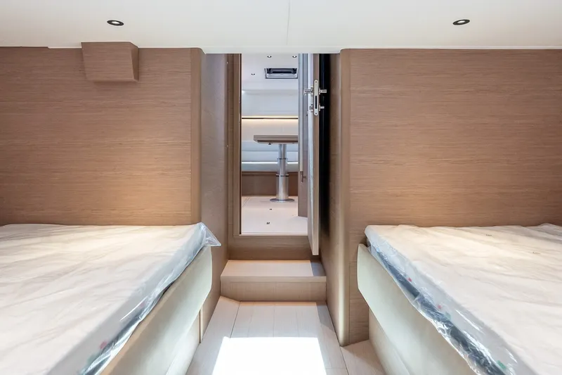 Slide: The Image of Interior of 2027 Pardo Yachts P43R, featuring twin beds and modern wood finish. - 30