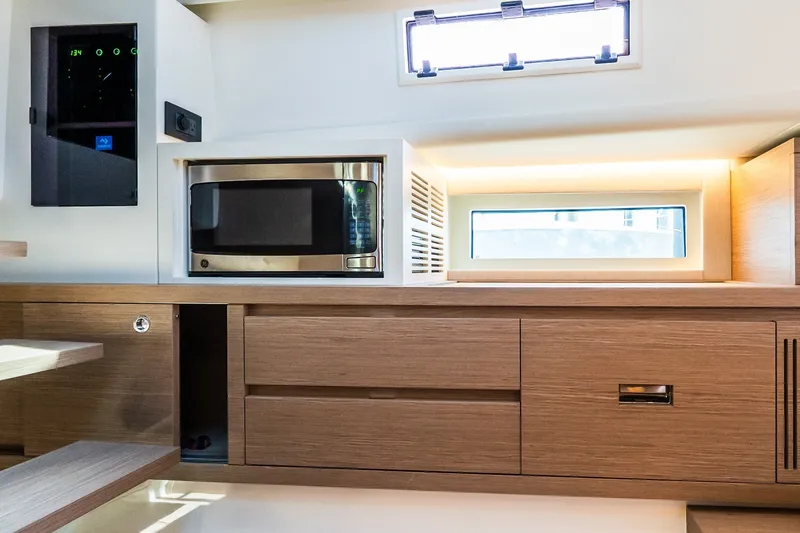 Slide: The Image of Modern kitchen interior of 2027 Pardo Yachts P43R with microwave and wooden cabinetry. - 33