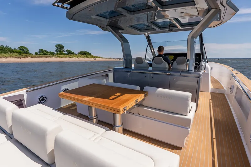 Slide: The Image of Luxurious 2027 Pardo Yachts P43R cruising on a sunny day, featuring elegant seating and a wooden table. - 15