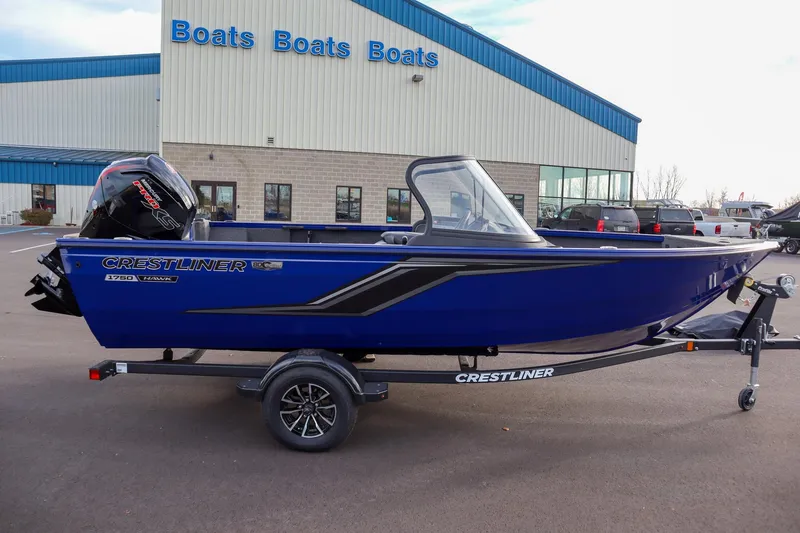 The Image of 2026 Crestliner 1750 Hawk boat in blue, parked outside dealership. - 0
