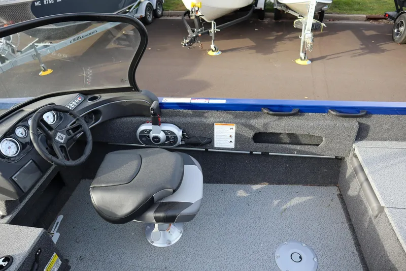 Slide: The Image of 2026 Crestliner 1750 Hawk boat interior with steering wheel and seat, showcasing dashboard controls. - 11