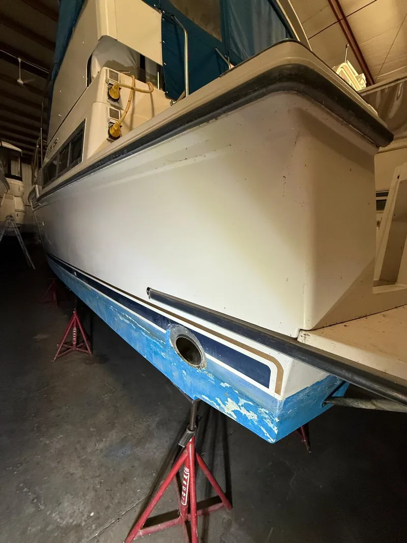 Slide: The Image of 1994 Carver 390 boat on stands in a storage facility. - 10