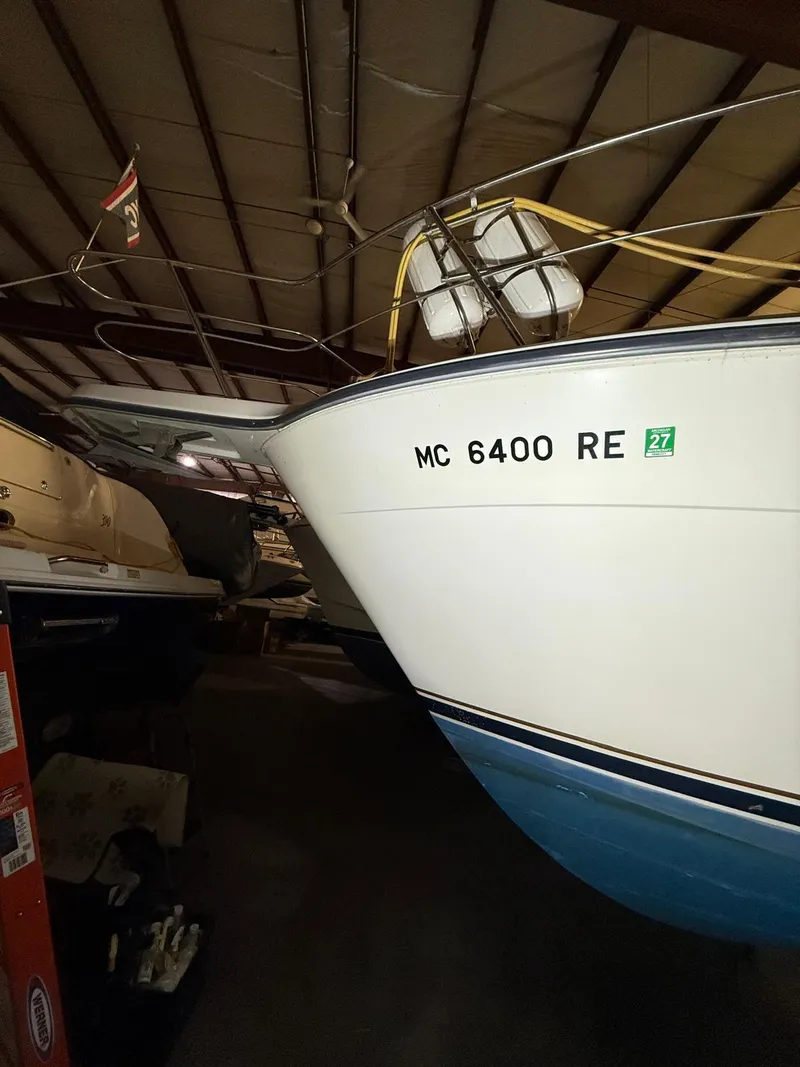 Slide: The Image of 1994 Carver 390 boat stored indoors, registration MC 6400 RE visible. - 13