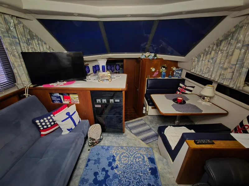 Slide: The Image of Interior of a 1994 Carver 390 yacht with cozy seating and nautical decor. - 24