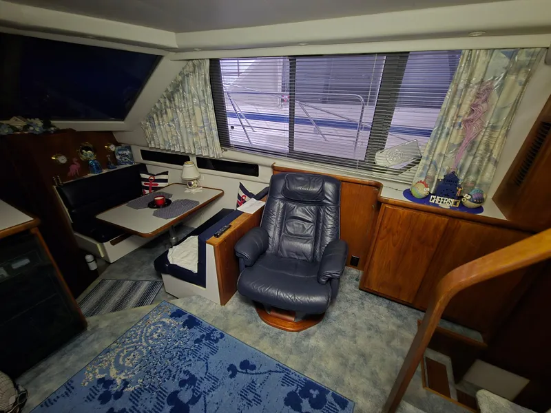 Slide: The Image of Interior of a 1994 Carver 390 yacht with leather chair and dining area. - 25