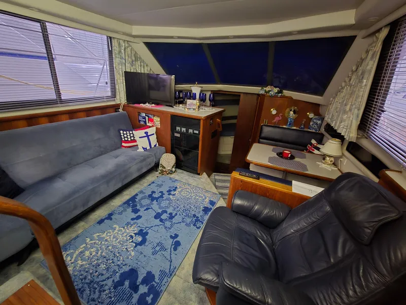 Slide: The Image of Interior of a 1994 Carver 390 yacht with cozy seating and nautical decor. - 37