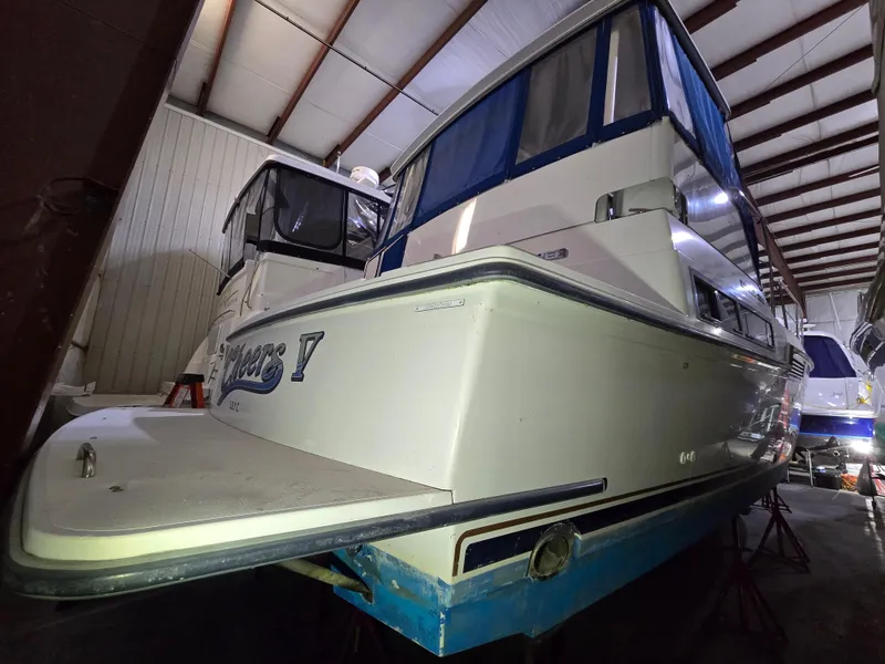 Slide: The Image of 1994 Carver 390 yacht in storage, featuring a white hull and blue accents. - 39