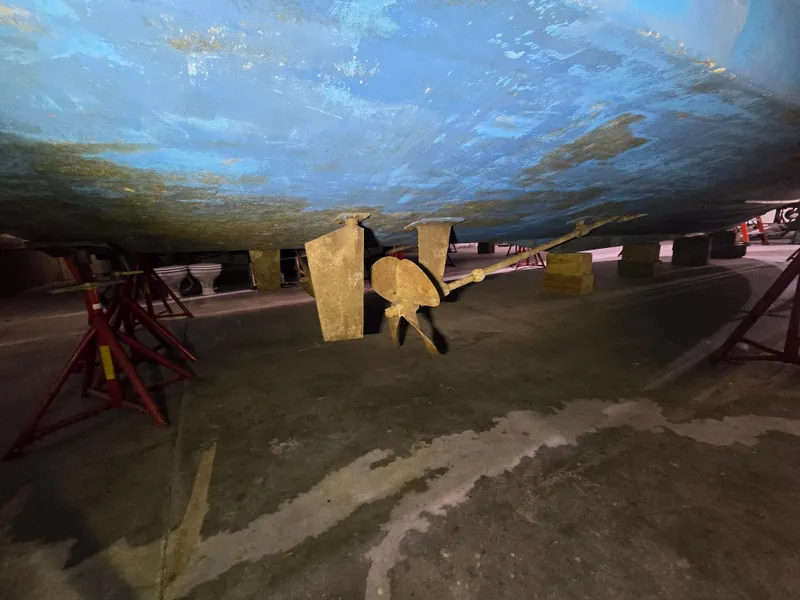 Slide: The Image of 1994 Carver 390 boat hull and propeller on stands in a workshop. - 40