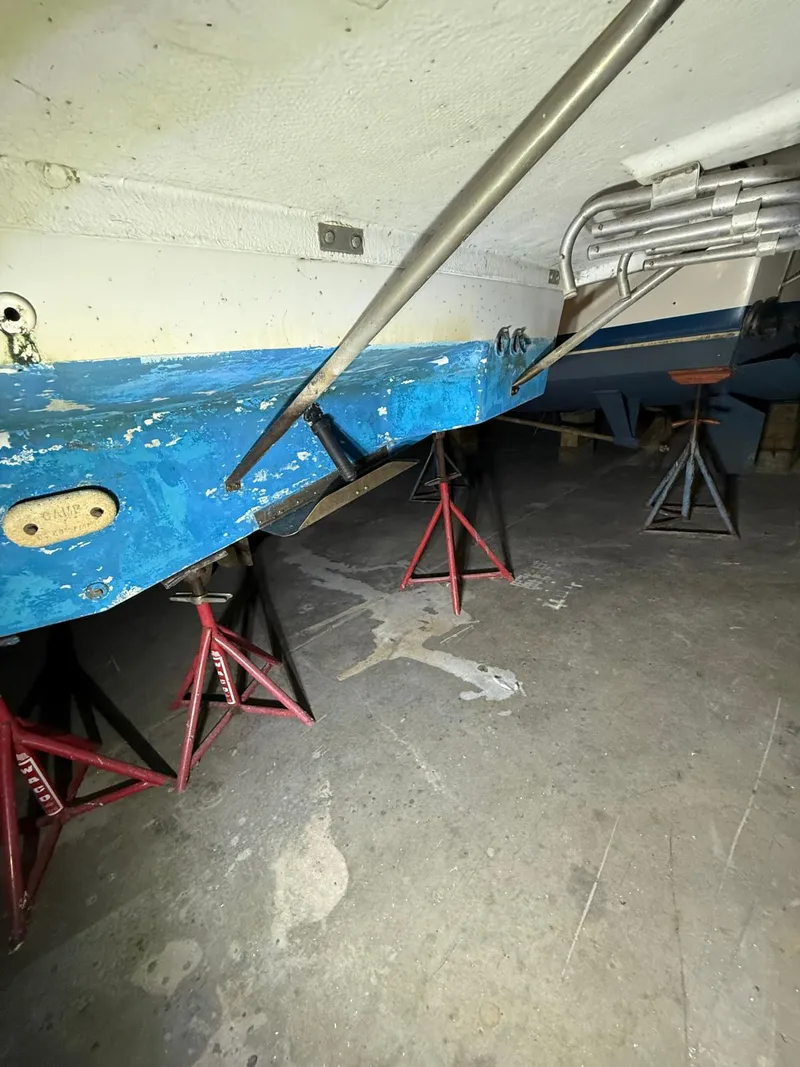 Slide: The Image of 1994 Carver 390 boat hull on stands in a workshop. - 5