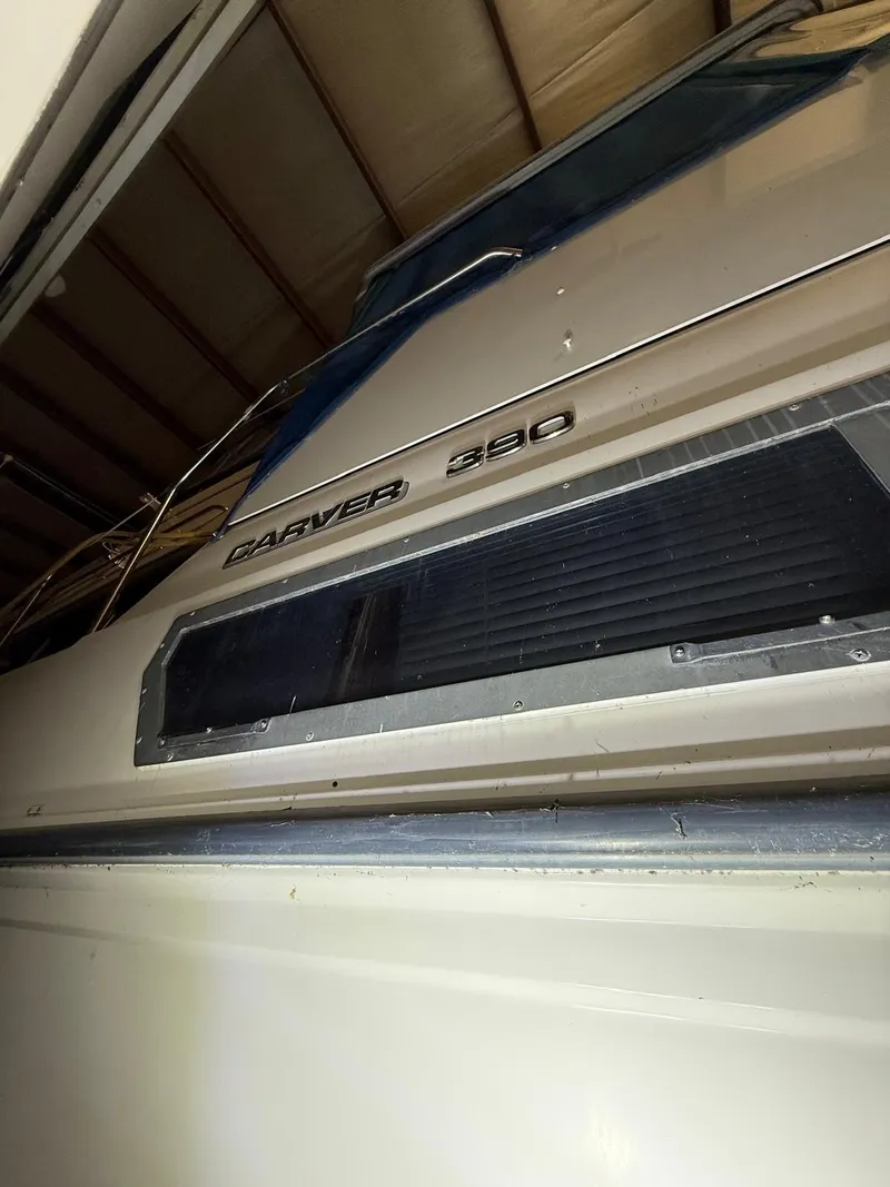 Slide: The Image of 1994 Carver 390 boat in storage, showcasing model name and sleek design. - 11