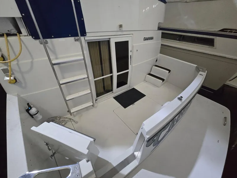 Slide: The Image of 1994 Carver 390 boat deck with ladder and seating area. - 16