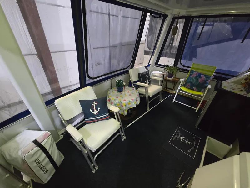 Slide: The Image of Interior of a 1994 Carver 390 boat with cozy seating and nautical decor. - 18