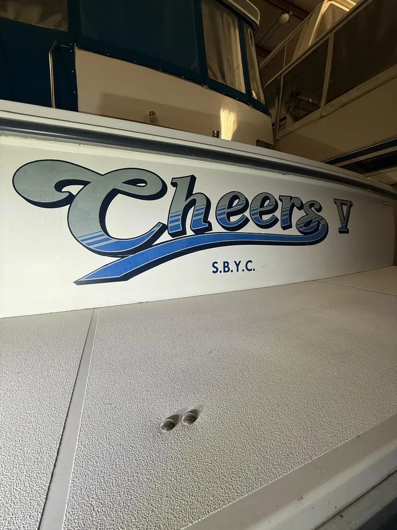 Slide: The Image of 1994 Carver 390 boat with "Cheers V" and "S.B.Y.C." lettering on the side. - 2