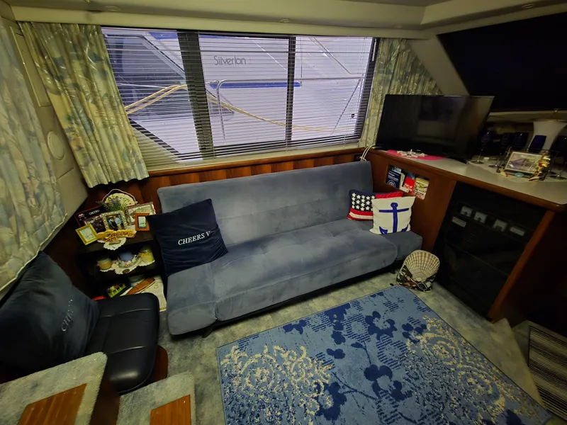 Slide: The Image of Interior of a 1994 Carver 390 yacht with cozy seating and nautical decor. - 23