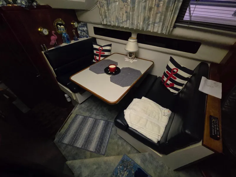 Slide: The Image of Interior of a 1994 Carver 390 boat with cozy dining area and nautical decor. - 26