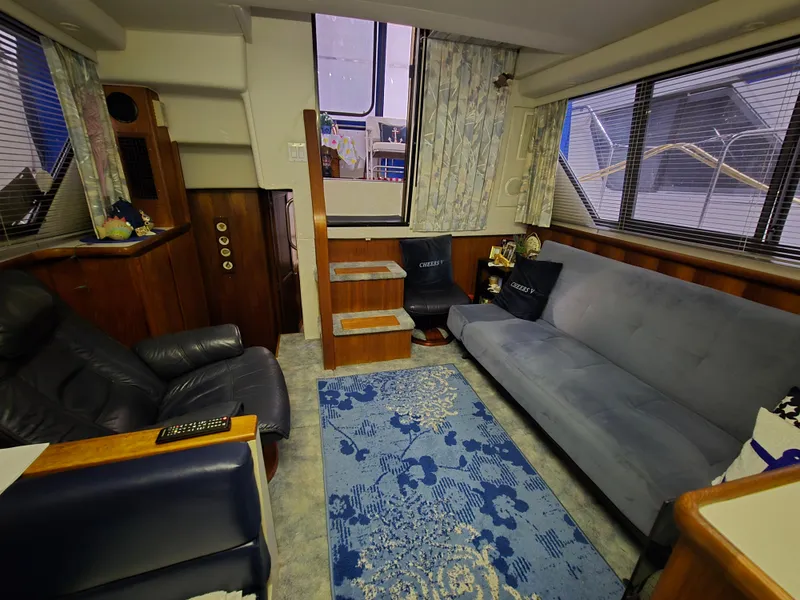 Slide: The Image of Interior of a 1994 Carver 390 yacht with cozy seating and nautical decor. - 31