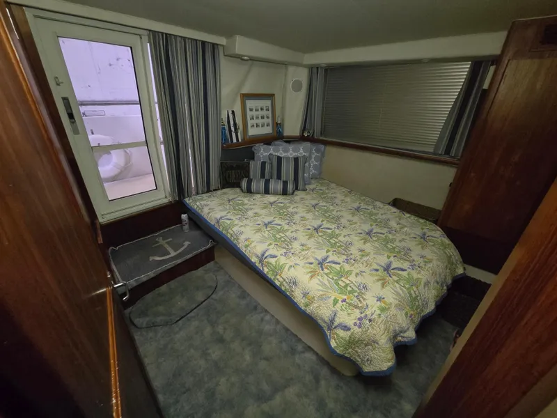 Slide: The Image of Cozy bedroom in 1994 Carver 390 yacht with floral bedding and nautical decor. - 34