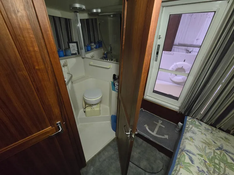 Slide: The Image of Bathroom interior of 1994 Carver 390 yacht with wooden door and nautical decor. - 35