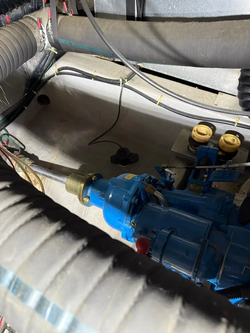 Slide: The Image of Engine compartment of a 1994 Carver 390 boat with visible mechanical components. - 9