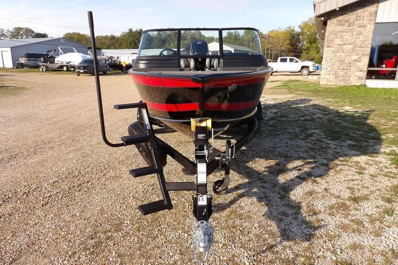 Slide: The Image of 2026 Lund 1775 Impact XS Sport boat on trailer, parked outdoors. - 15