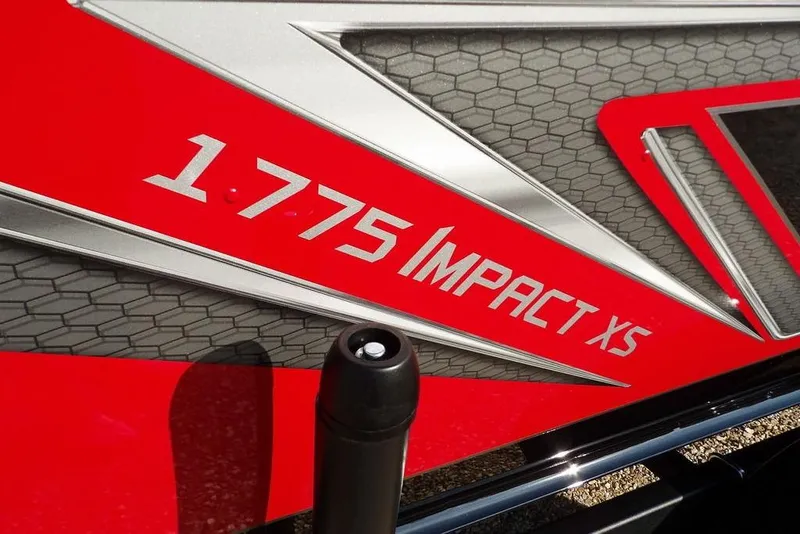 Slide: The Image of 2026 Lund 1775 Impact XS Sport boat logo on red and silver design. - 2