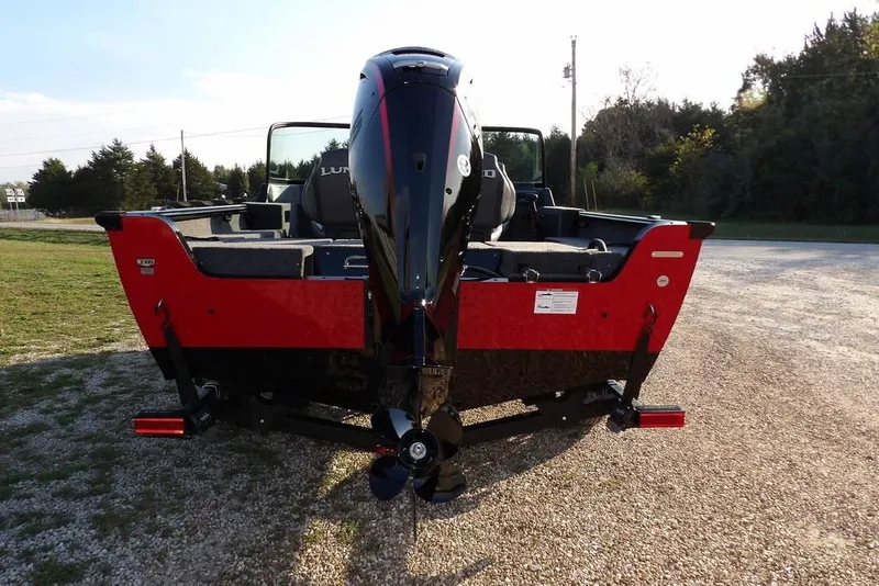 Slide: The Image of 2026 Lund 1775 Impact XS Sport boat, rear view, parked on gravel. - 20