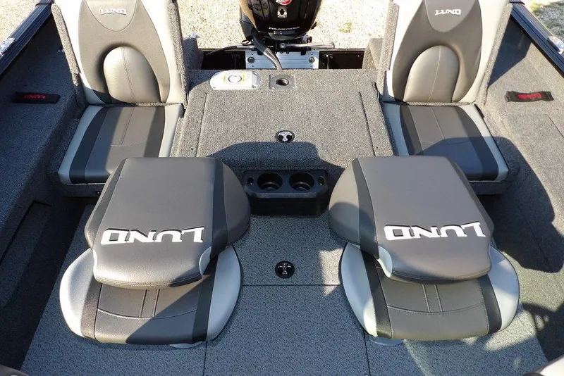 Slide: The Image of 2026 Lund 1775 Impact XS Sport boat interior with gray seating and storage compartments. - 23