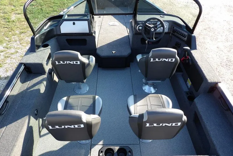 Slide: The Image of 2026 Lund 1775 Impact XS Sport boat interior with four seats and steering console. - 29