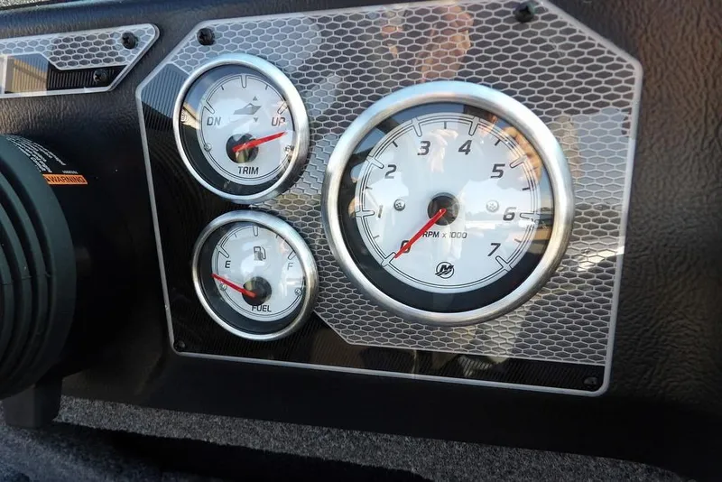 Slide: The Image of Dashboard gauges of 2026 Lund 1775 Impact XS Sport boat, featuring RPM, trim, and fuel indicators. - 30