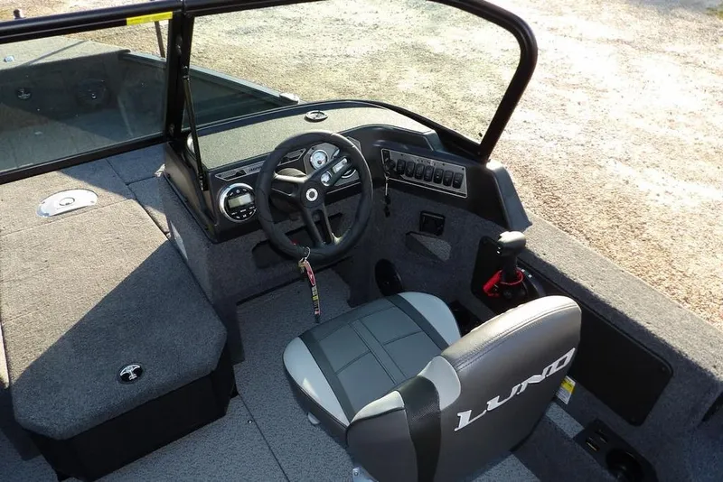 Slide: The Image of 2026 Lund 1775 Impact XS Sport boat interior with steering wheel and seating. - 35