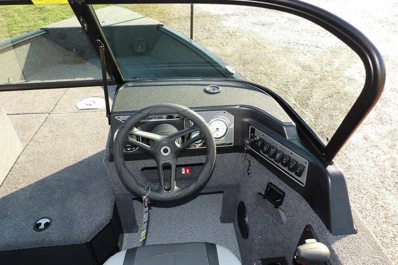 Slide: The Image of 2026 Lund 1775 Impact XS Sport boat cockpit with steering wheel and control panel. - 36