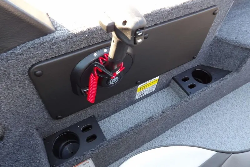 Slide: The Image of 2026 Lund 1775 Impact XS Sport boat interior with control panel and cup holders. - 39