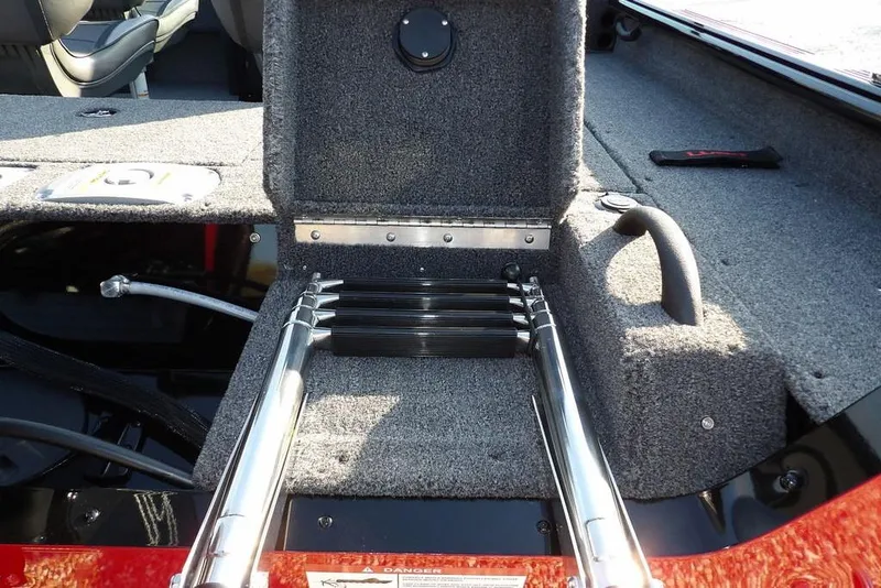 Slide: The Image of 2026 Lund 1775 Impact XS Sport boat interior with foldable ladder and carpeted deck. - 4