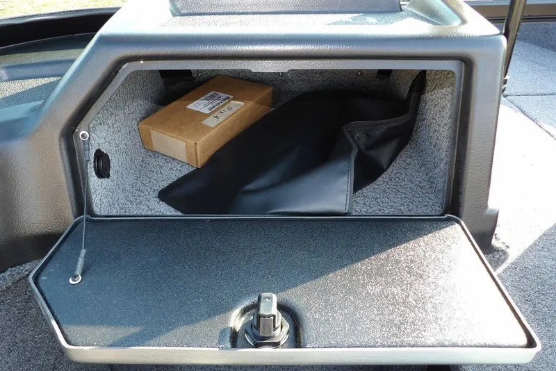 Slide: The Image of Storage compartment in 2026 Lund 1775 Impact XS Sport boat, featuring a box and cover. - 40