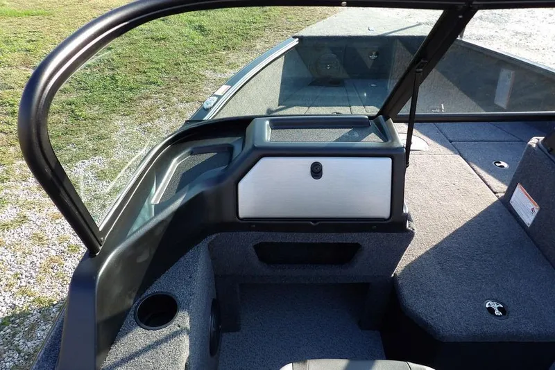 Slide: The Image of 2026 Lund 1775 Impact XS Sport boat interior with windshield and carpeted deck. - 42