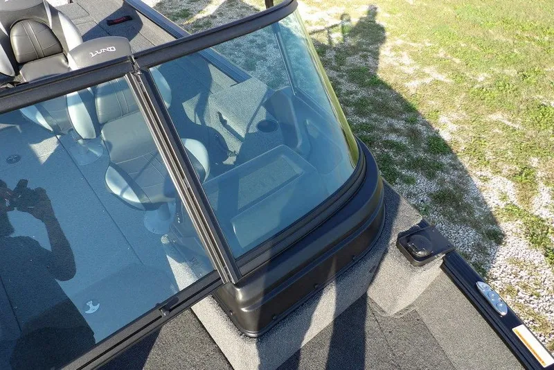 Slide: The Image of 2026 Lund 1775 Impact XS Sport boat interior with windshield and seating. - 47