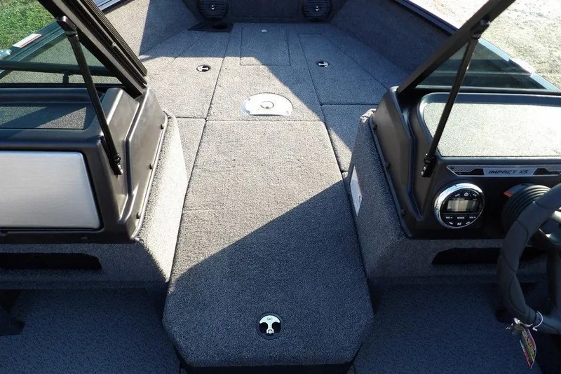 Slide: The Image of 2026 Lund 1775 Impact XS Sport boat interior with carpeted deck and control panel. - 51