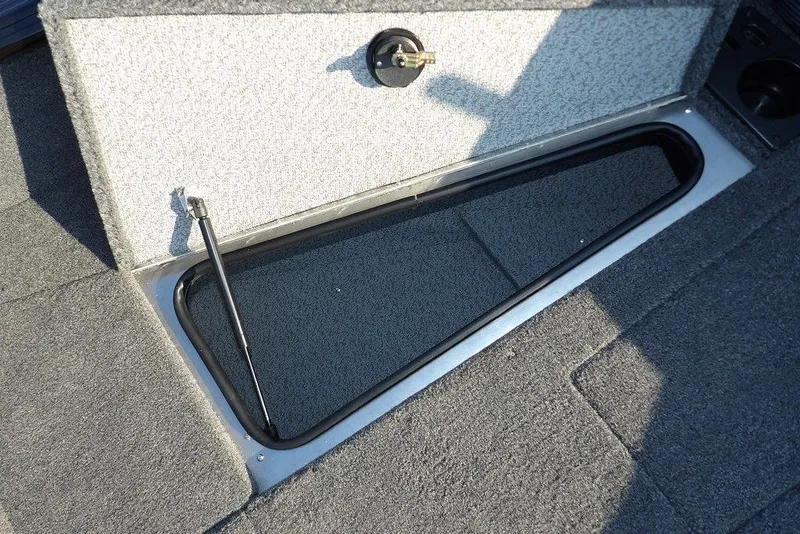 Slide: The Image of 2026 Lund 1775 Impact XS Sport boat storage compartment with open lid. - 53
