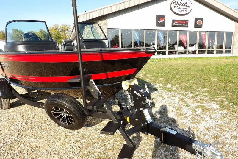 Slide: The Image of 2026 Lund 1775 Impact XS Sport boat on trailer outside marine center. - 58