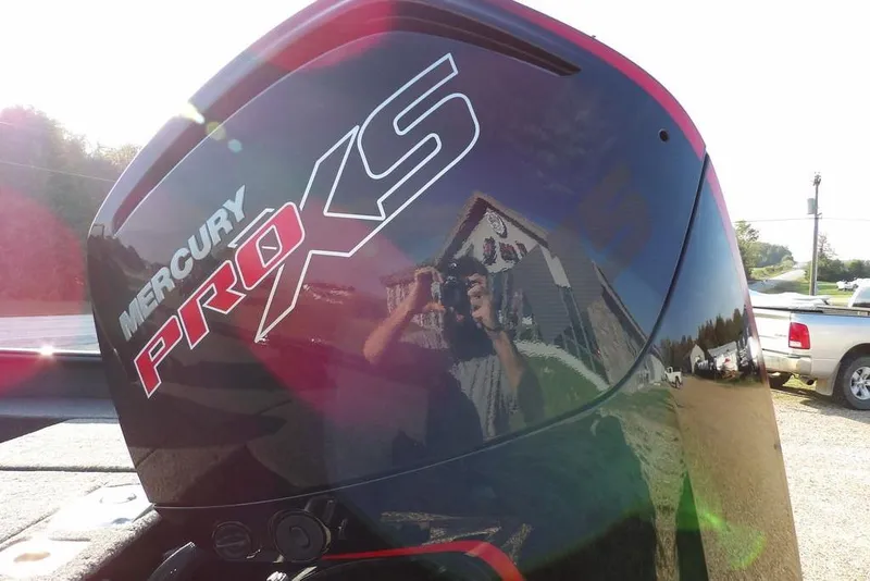 Slide: The Image of Mercury Pro XS engine on 2026 Lund 1775 Impact XS Sport boat, reflecting surroundings. - 7