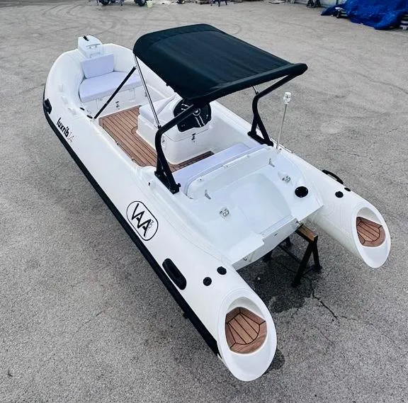 Slide: The Image of 2024 Aqvaboats LUXRIB 14 inflatable boat with black canopy and wooden deck. - 11