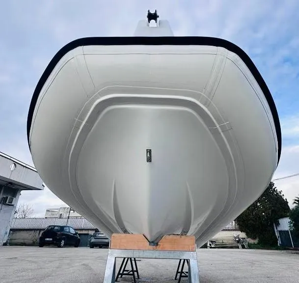 Slide: The Image of 2024 Aqvaboats LUXRIB 14 boat hull on a stand, viewed from the front. - 14