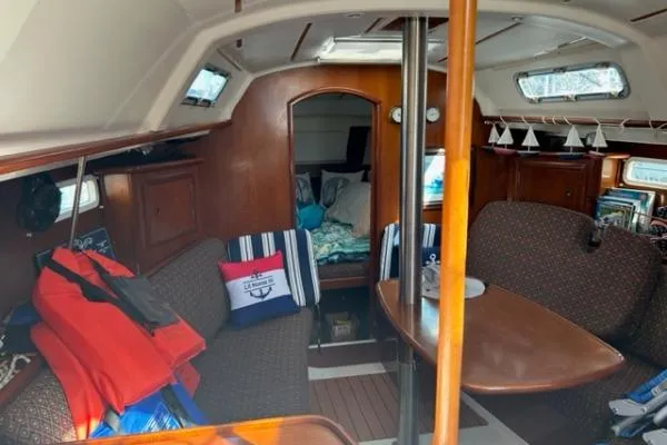 Slide: The Image of 2003 Beneteau 331 sailboat interior with cozy seating and nautical decor. - 13