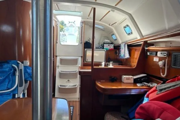 Slide: The Image of Interior of 2003 Beneteau 331 sailboat, featuring cozy cabin and navigation area. - 14